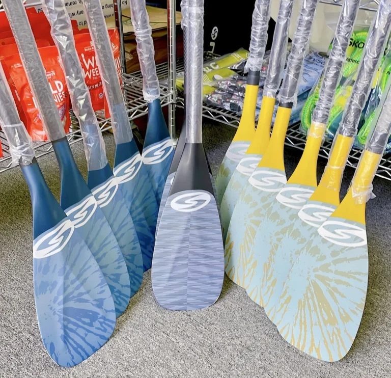 A rack of paddle blades in blue and yellow.