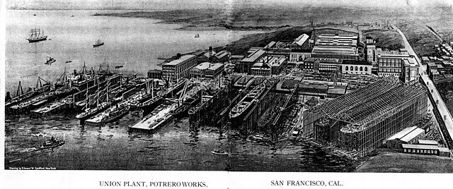 A historic photograph of the Union Iron Works plant at Potrero, its piers and sheds lining the waterfront.