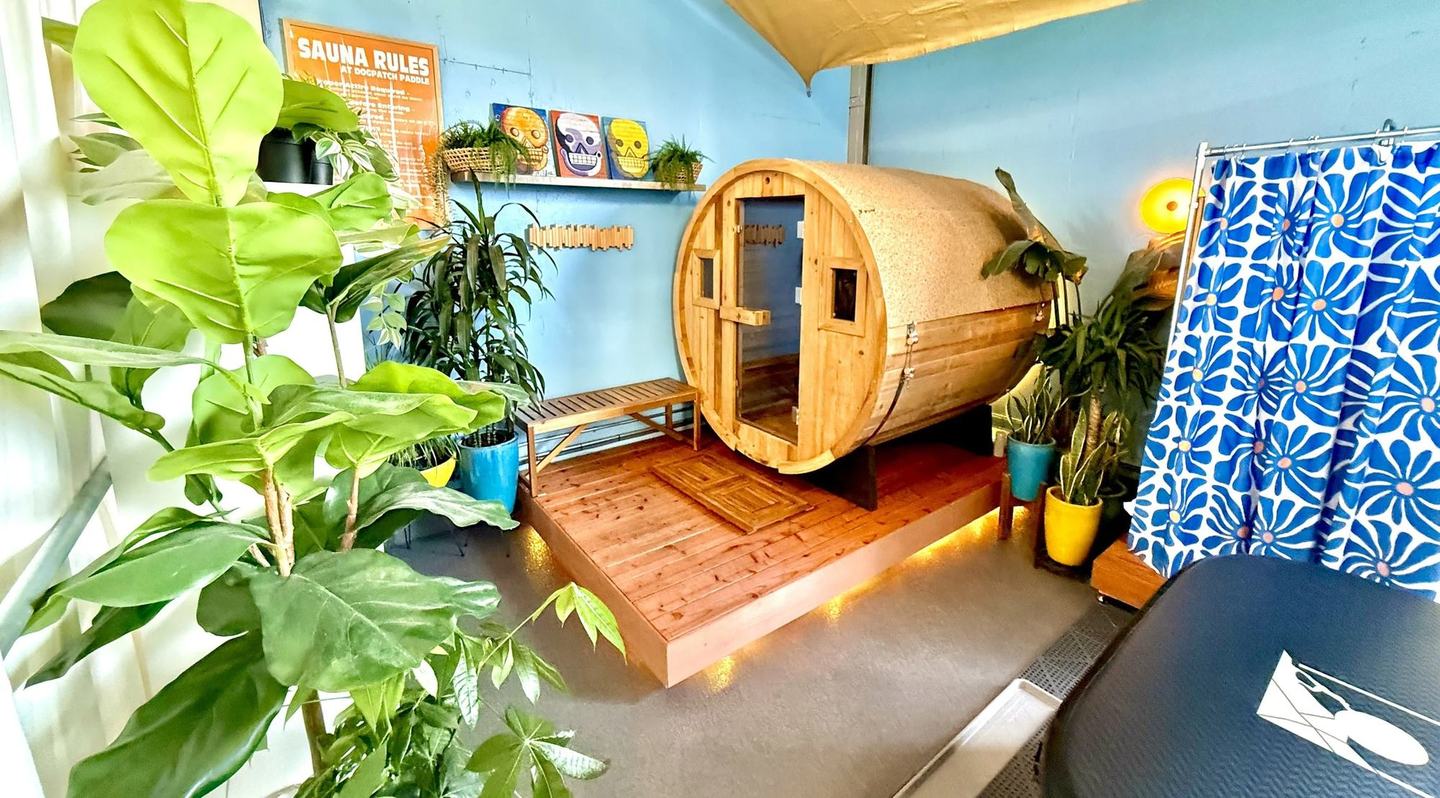 The barrel sauna at Crane Cove Park, the deck in front of it and the towel rail beside