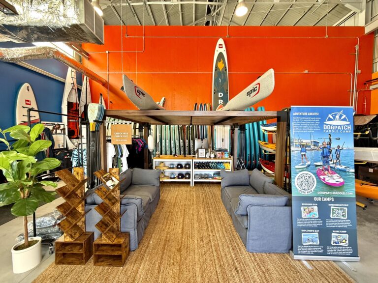 Inside the shop at Crane Cove, boards on the orange wall and the counter beyond.